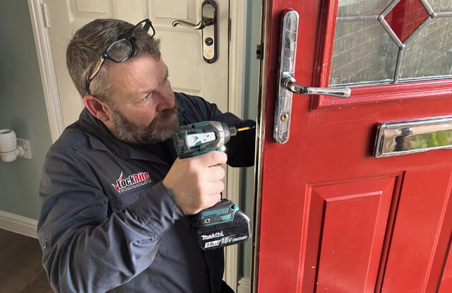 Locksmith replacing a lock mechanism