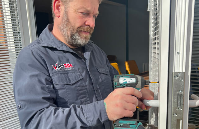 Locksmith replacing a uPVC door handle